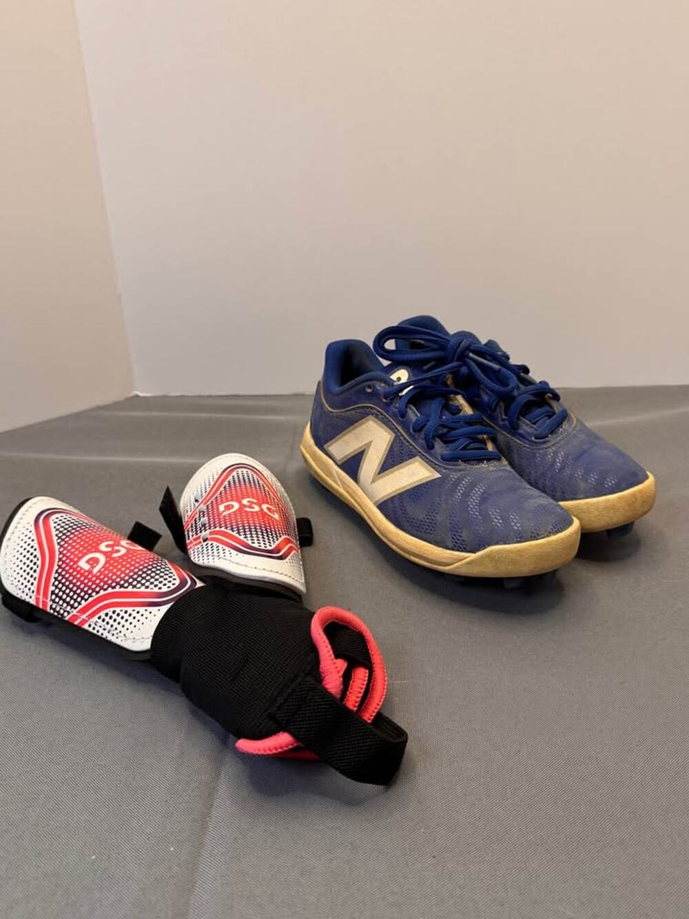 New Balance 4040V7 youth 12.5 cleats and DSG shin guards (small)